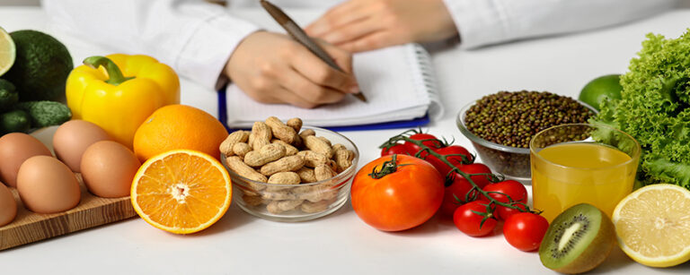 Young,Female,Nutritionist,With,Healthy,Food,Writing,Diet,Plan,In